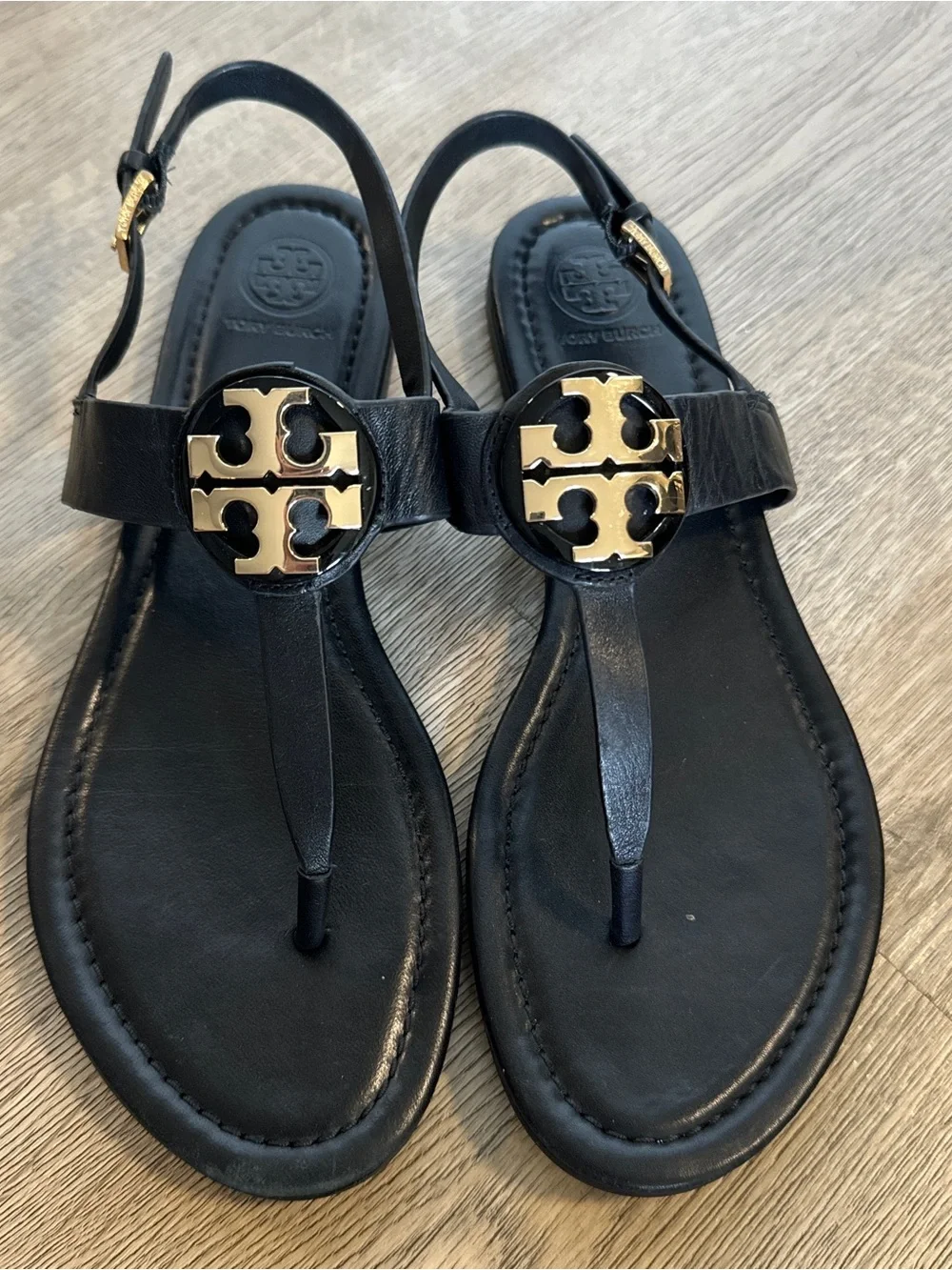 Tory Burch Black Leather T-Strap Sandals with Gold Logo Medallion
